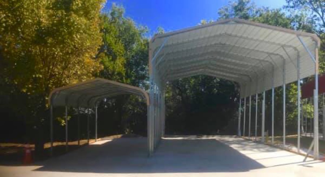 Metal covered carport RV sites on clean concrete pads at ABC RV Park